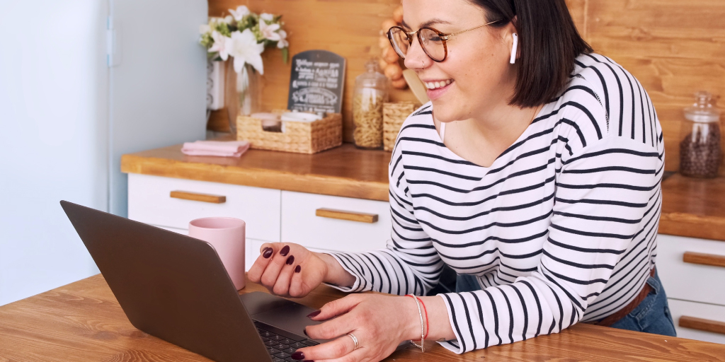 Woman engages with customer service queries at home on laptop.